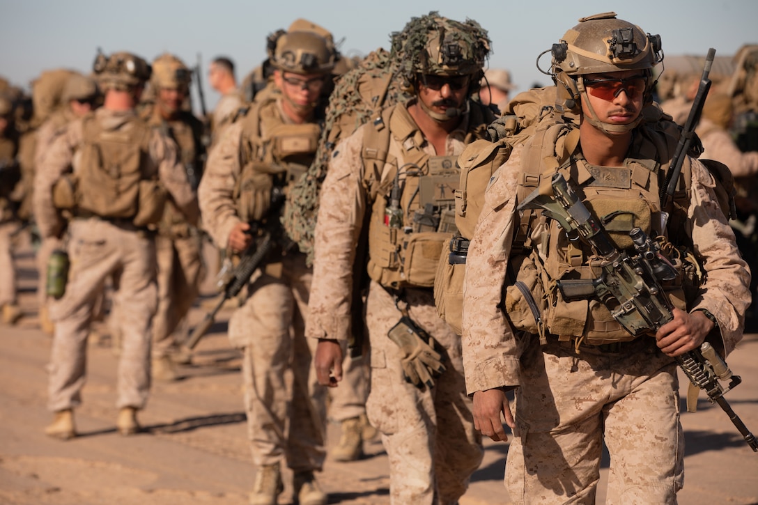 U.S. Marines with Echo Company, 2nd Battalion, 5th Marine Regiment, 1st Marine Division, prepare to board an MV-22B Osprey assigned to Marine Medium Tiltrotor Squadron (VMM) 164, Marine Aircraft Group 39, 3rd Marine Aircraft Wing, for a simulated airfield seizure during a mission rehearsal exercise as part of Exercise Steel Knight 23.2 at Marine Corps Air Station Yuma, Arizona, Dec 2, 2023. Steel Knight maintains and sharpens I Marine Expeditionary Force as America’s expeditionary force in readiness – organized, trained and equipped to respond to any crisis, anytime, anywhere. This exercise will certify 5th Marines to be forward-postured in Australia as Marine Rotational Force - Darwin, a six-month deployment during which Marines train with Australian allies and facilitate rapid response to crises and contingencies. (U.S. Marine Corps photo by Cpl. Migel A. Reynosa)