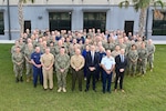 Guest speakers and participants take part in the annual group photo commemorating U.S. Naval Forces Southern Command/U.S. 4th Fleet's annual Maritime Synchronization Symposium at Naval Station Mayport Dec. 5-8, 2023. This year's symposium featured four guest speakers, expert panels, and question and answer sessions for regional Foreign Area Officers (FAOs) to discuss mutual challenges and opportunities, get the latest information on strategy and upcoming operations and exercises, and learn more about the Navy's strategic competition with the People's Republic of China and U.S. 4th Fleet's campaign to inform the hybrid fleet. USNAVSO/FOURTHFLT is the trusted maritime partner for Caribbean, Central and South America maritime forces leading to improved unity, security and stability.