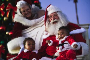 U.S. Air Force Brig. Gen. Jason Rueschhoff (right), 56th Fighter Wing commander, and Chief Master Sgt. Jason Shaffer (left), 56th Fighter Wing command chief, address Luke Air Force Base personnel and their families during a Holiday Magic event.