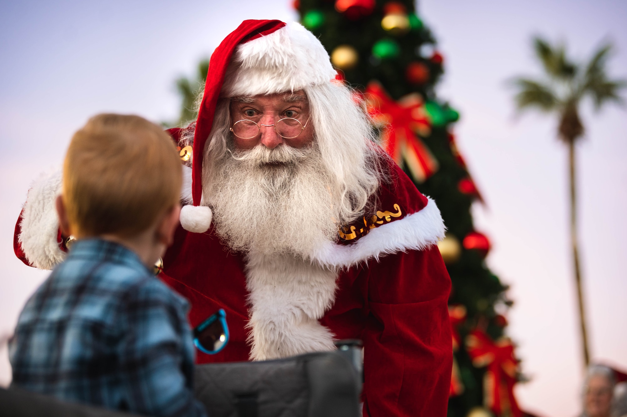 Santa Claus interacts with a military child.