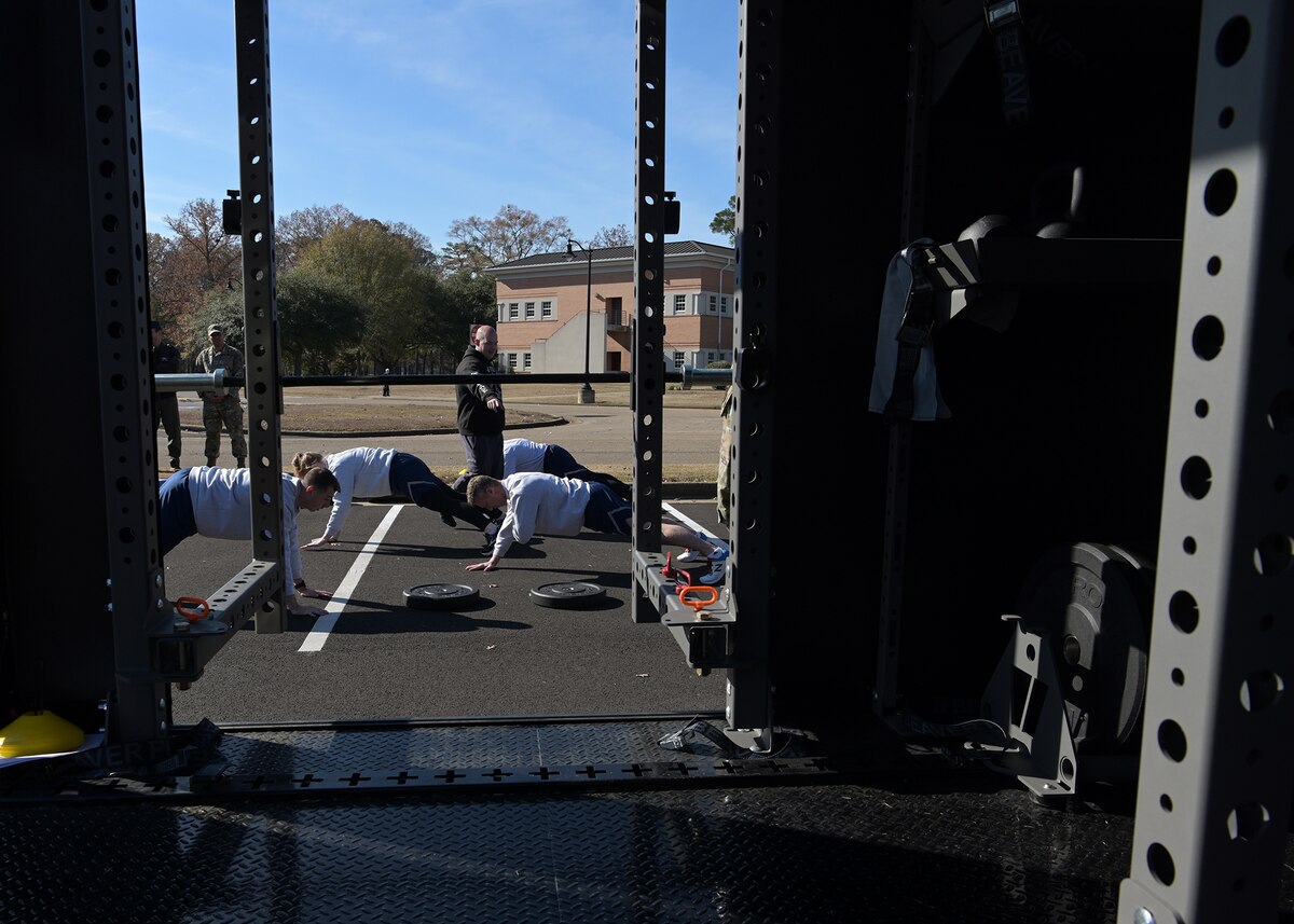 Airmen perform fitness exercises.