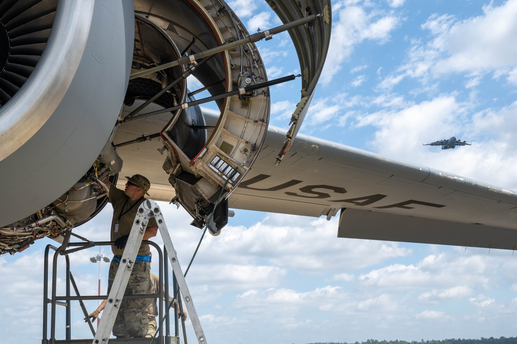 U.S. Air Force Tech. Sgt. Anthony Goodman, 15th Aircraft Maintenance Squadron engines technician, inspects the engine of a C-17 Globemaster III during Exercise Global Dexterity 23-2 at Royal Australian Air Force Base Amberley, Nov. 29, 2023.  Exercise Global Dexterity prepares our air forces for combined action in wartime, peacetime and humanitarian operations throughout the Indo-Pacific. (U.S. Air Force photo by Senior Airman Makensie Cooper)