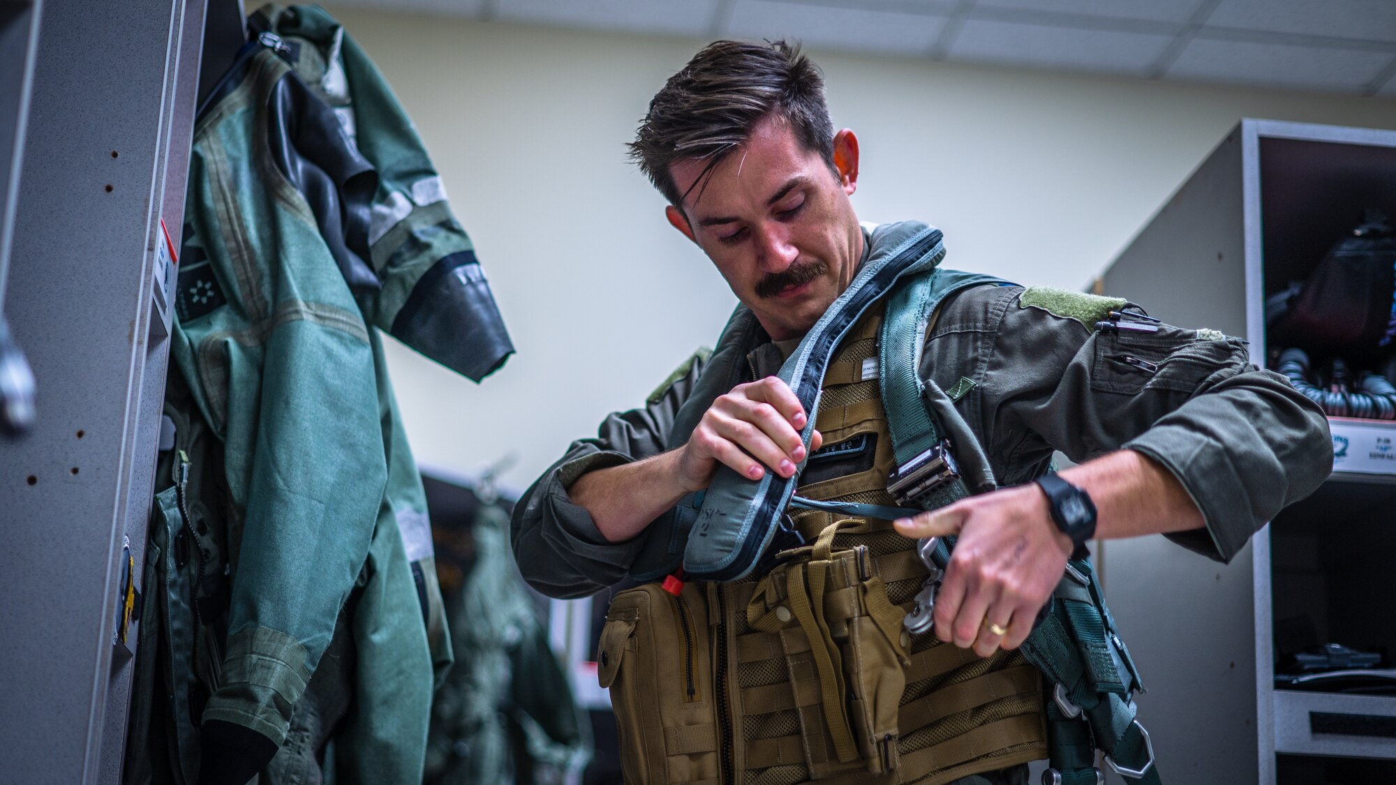 Capt. Tyler Hansen, dons flight gear before a large force training exercise.