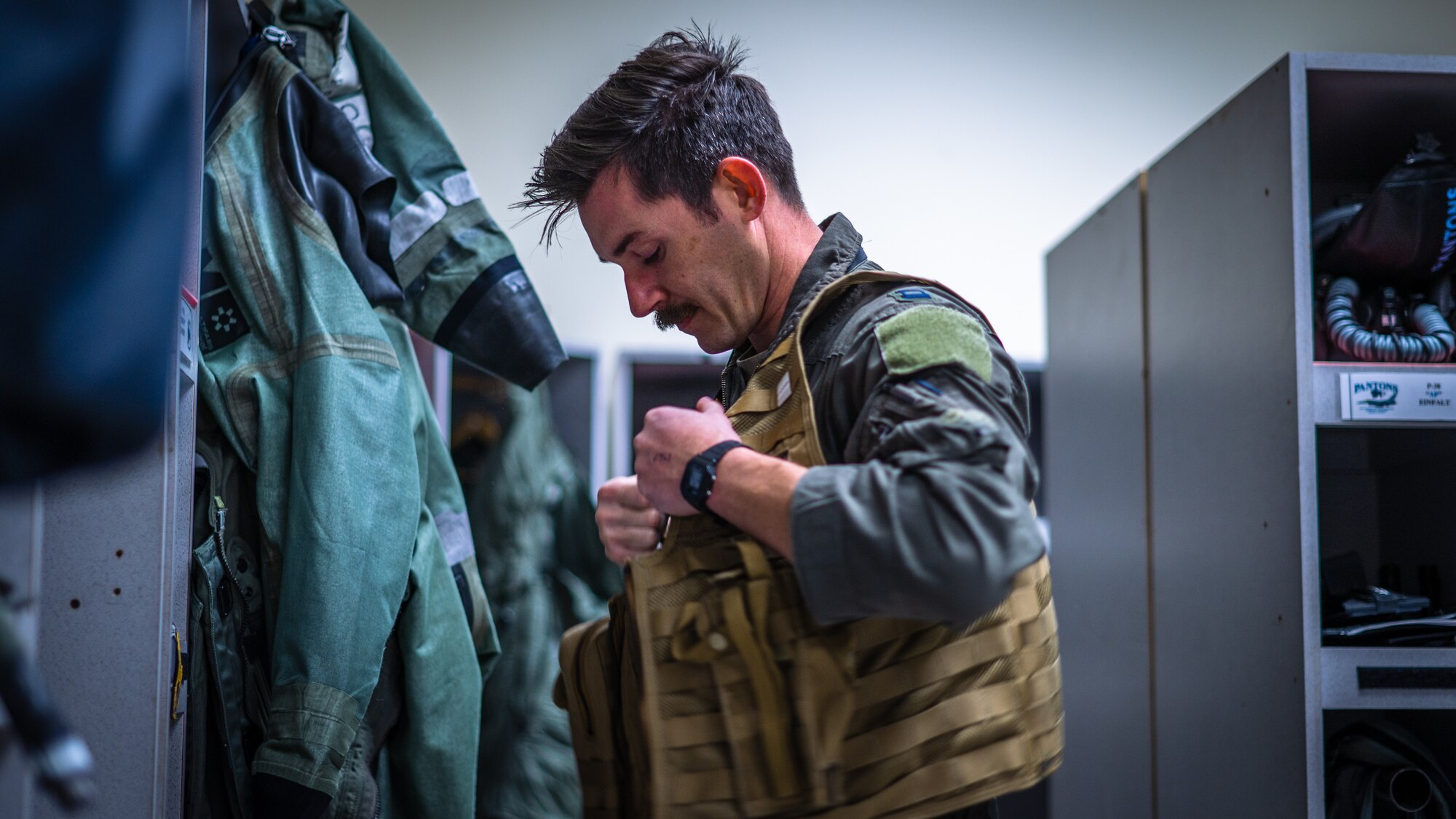 Capt. Tyler Hansen dons flight gear before a large force training exercise.
