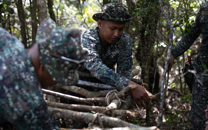 Philippine Marines with Marine Battalion Landing Teams 8 and 10 build a wooden shelter at a jungle shelter class during KAMANDAG 7 at Paredes Air Station, Philippines, Nov. 10, 2023. KAMANDAG is an annual Philippine Marine Corps and U.S. Marine Corps led exercise aimed at improving multinational readiness, relationships, and mutual capabilities in the advancement of a Free and Open Indo-Pacific. This year marks the seventh iteration of this exercise and includes participants from Japan, the Republic of Korea, and observers from the United Kingdom. (U.S. Marine Corps photo by Sgt. Jacqueline C. Parsons)