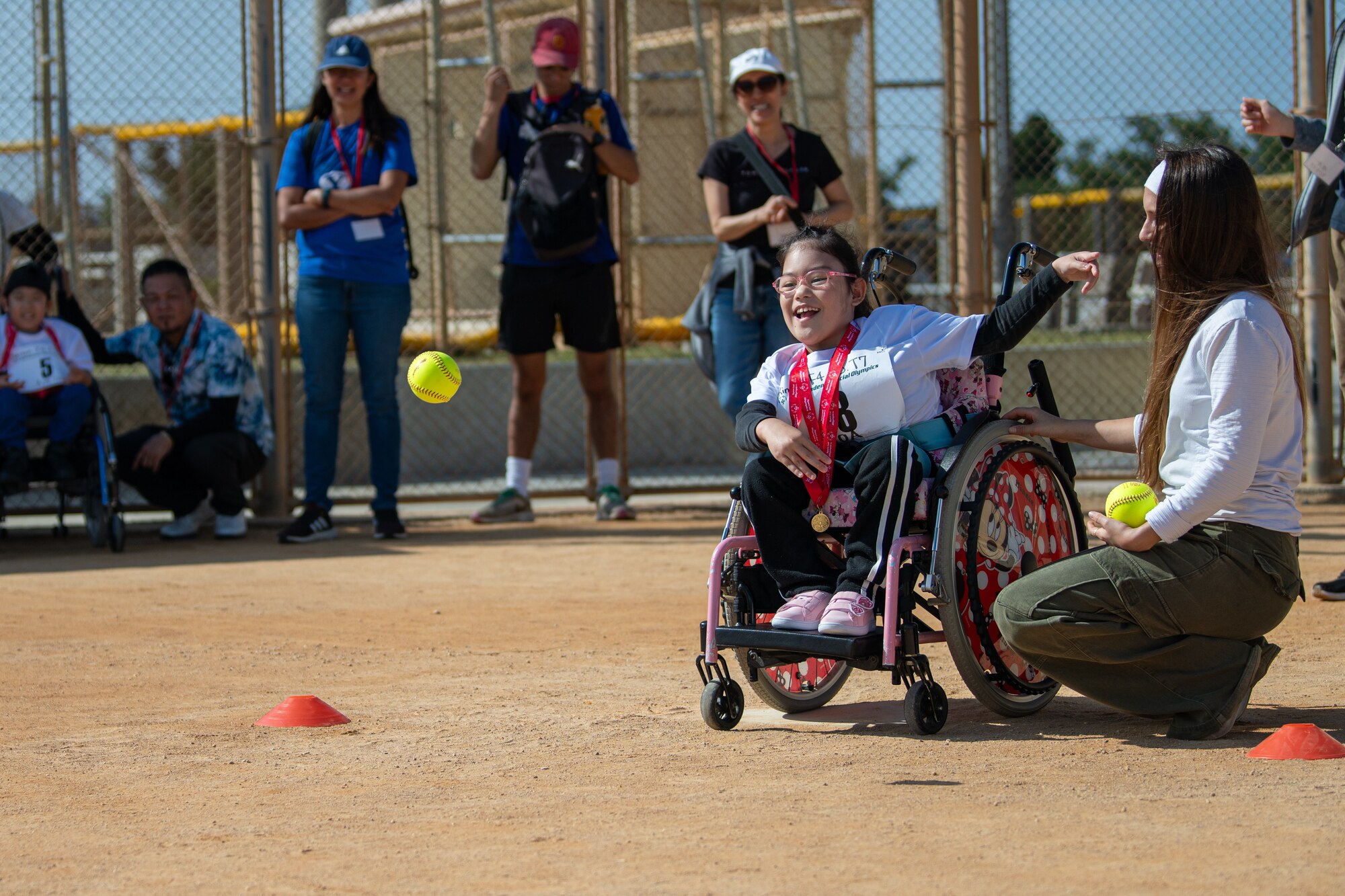 An athlete throws a softball.