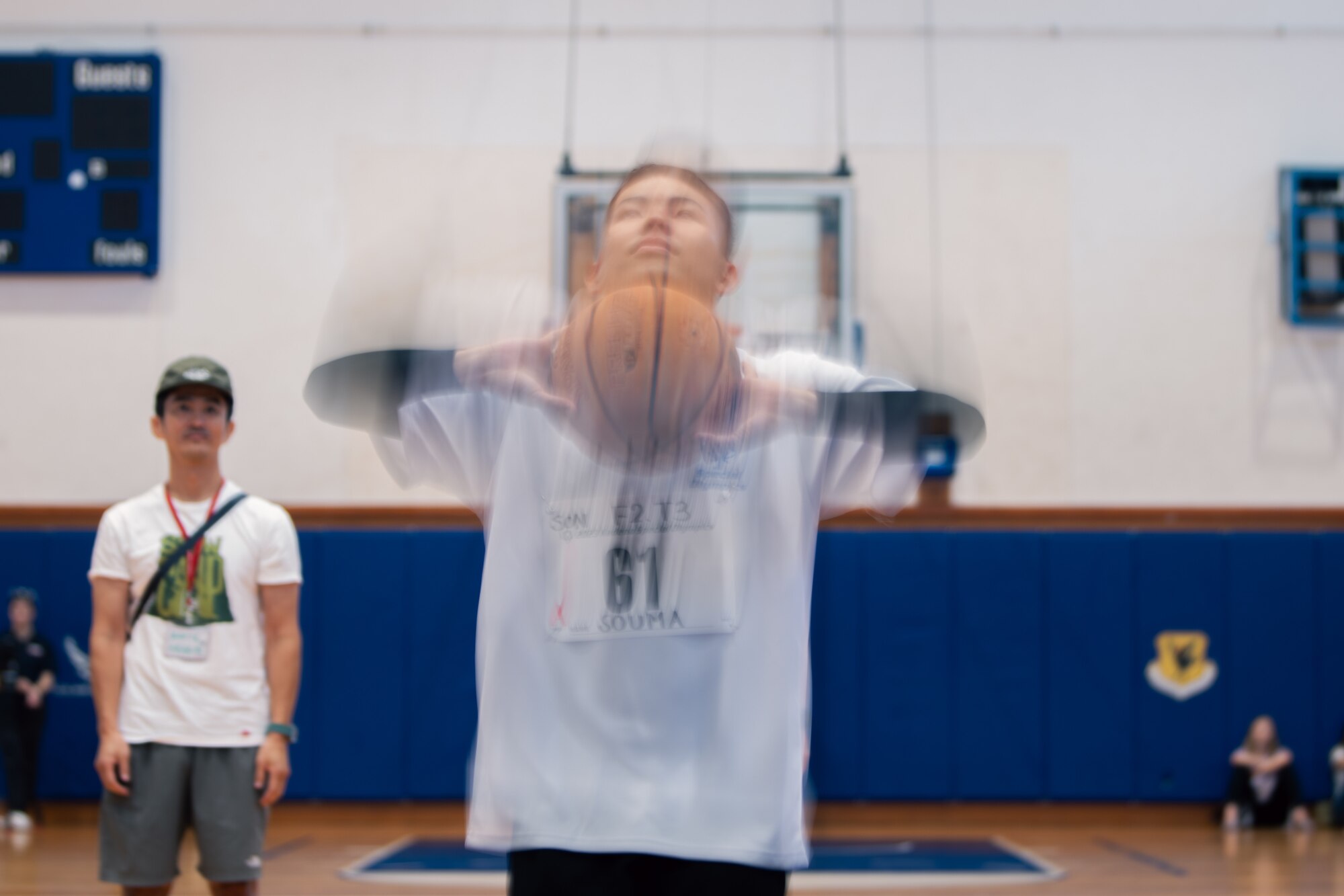An athlete shoots a basketball.