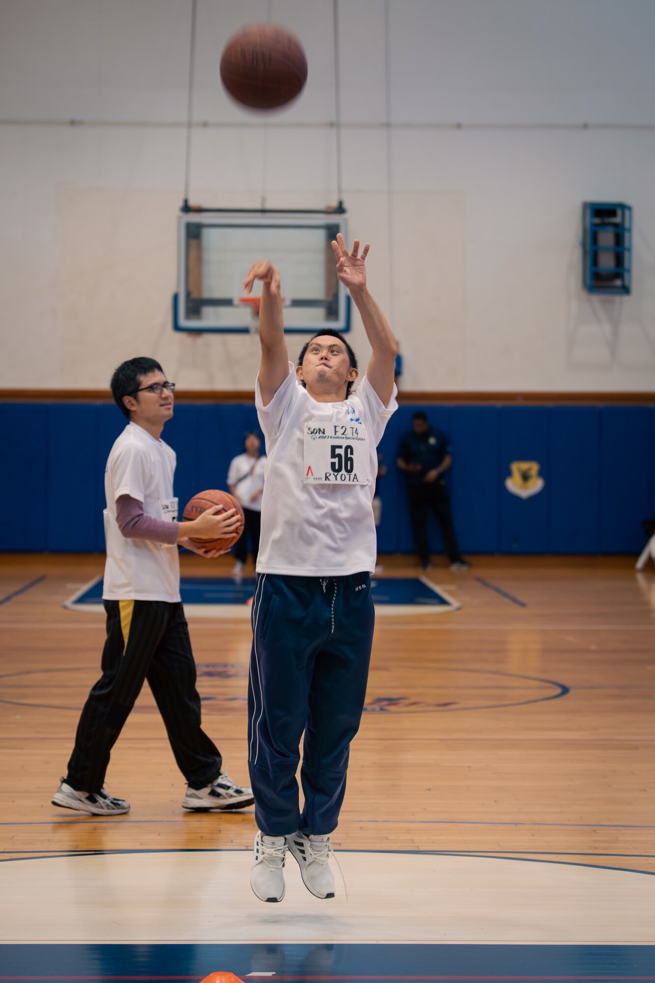 An athlete shoots a basketball.