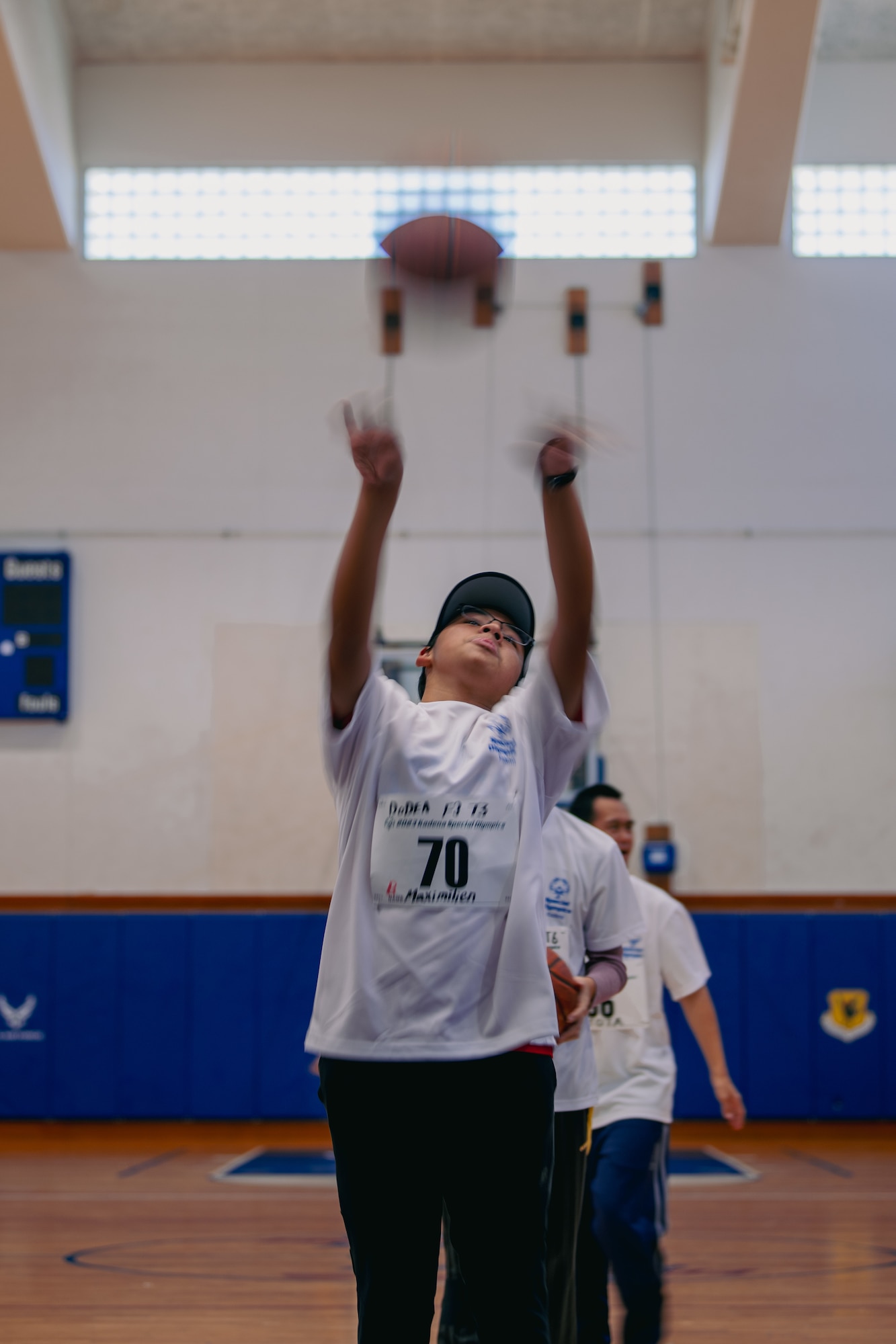 An athlete shoots a basketball.