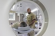 radiologist demonstrates a CT scanner