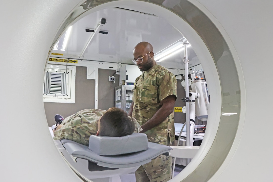 radiologist demonstrates a CT scanner