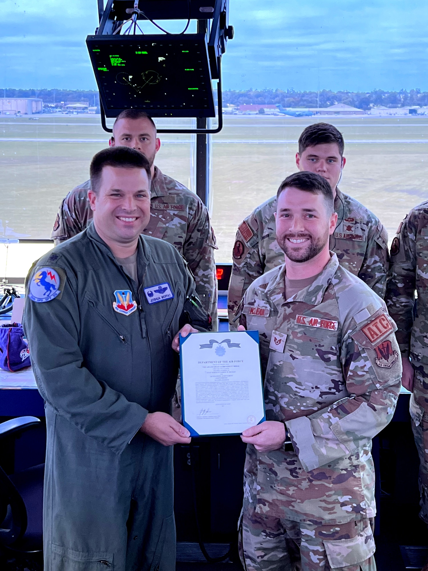U.S. Air Force Staff Sgt. Samuel McLean, 20th Operations Support Squadron (OSS) Air Traffic Control watch supervisor, right, receives an Air and Space Achievement Medal from Lt. Col. Joshua Moffat, 20th OSS commander, at Shaw Air Force Base, S.C., Sept. 28 2023.