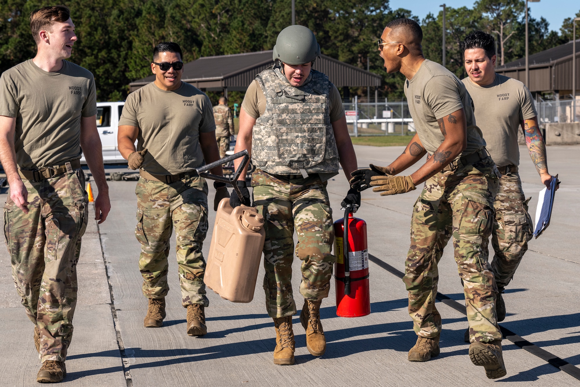 U.S. Air Force Staff Sgt. Mike Huynh, center, 23rd Logistic Readiness Squadron distribution supervisor, tries out for the forward area refueling point team