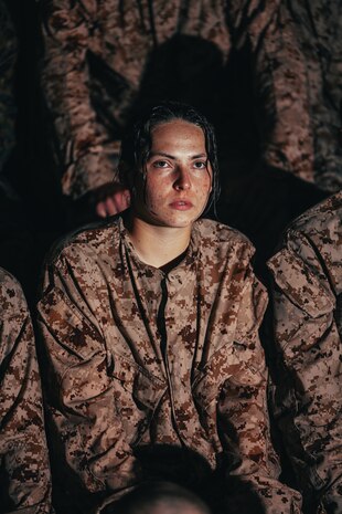 U.S. Marine Corps Recruit Hailey Shellum with Echo Company, 2nd Recruit Training Battalion, receives a brief on swim techniques at Marine Corps Recruit Depot San Diego, Dec. 11, 2023. Basic swim qualification teaches recruits essential skills for executing water maneuvers and promotes combat readiness amongst recruits. Shellum is a native of San Tan Valley, Arizona. (U.S. Marine Corps photo by Sgt. Jesse K. Carter-Powell)