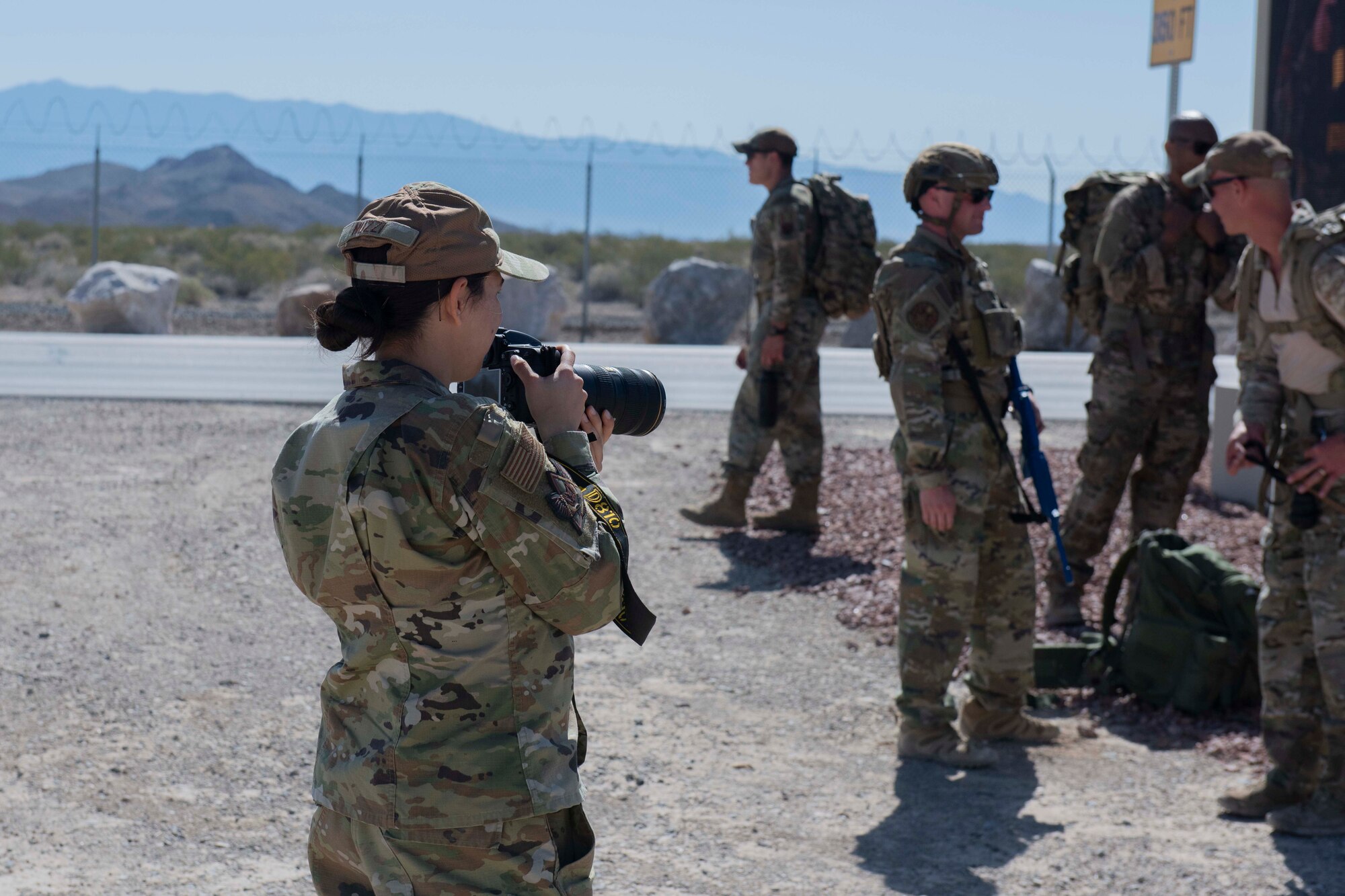 An airman takes photos of Security Forces airmen.