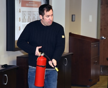 Firefighter/paramedic Christopher Crown explains how to properly use a fire extinguisher during U.S. Army Medical Logistics Command’s safety stand-down event Dec. 7, 2023, at Fort Detrick, Maryland.