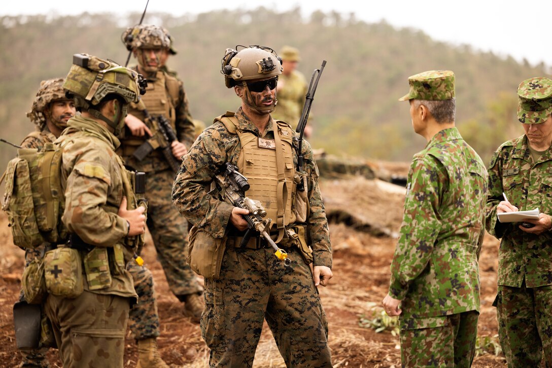 U.S. Marine Maj. Matthew Dunlevy, the commanding officer of Lima Company, 3rd Battalion, 1st Marine Regiment (Reinforced), Marine Rotational Force – Darwin 23, talks to during Exercise Southern Jackaroo 23 in Townsville Field Training Area, Queensland, Australia, July 4, 2023. Southern Jackaroo is a trilateral exercise with MRF-D, Japanese Ground Self-Defense Force, and Australian Defence Force, with Republic of Korea observers, working together to achieve fire, maneuver, and communications interoperability objectives. Dunlevy is a native of Kennett Square, Pennsylvania. (U.S. Marine Corps photo by Cpl. Brayden Daniel)