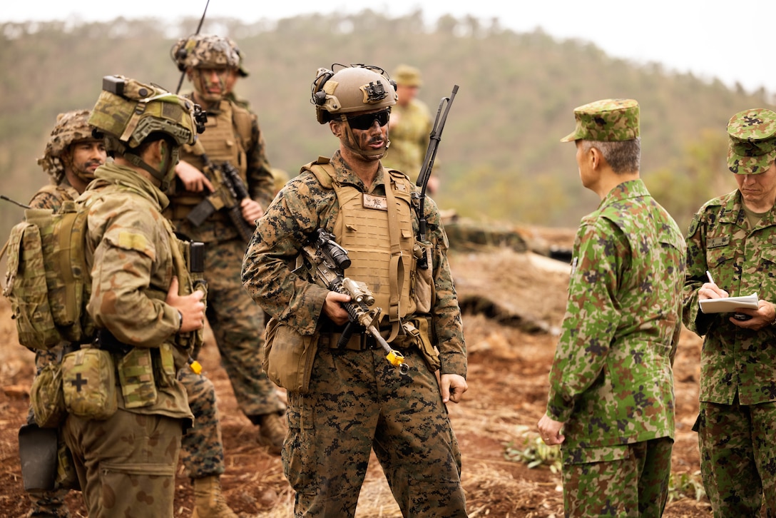 U.S. Marine Maj. Matthew Dunlevy, the commanding officer of Lima Company, 3rd Battalion, 1st Marine Regiment (Reinforced), Marine Rotational Force – Darwin 23, talks to during Exercise Southern Jackaroo 23 in Townsville Field Training Area, Queensland, Australia, July 4, 2023. Southern Jackaroo is a trilateral exercise with MRF-D, Japanese Ground Self-Defense Force, and Australian Defence Force, with Republic of Korea observers, working together to achieve fire, maneuver, and communications interoperability objectives. Dunlevy is a native of Kennett Square, Pennsylvania. (U.S. Marine Corps photo by Cpl. Brayden Daniel)