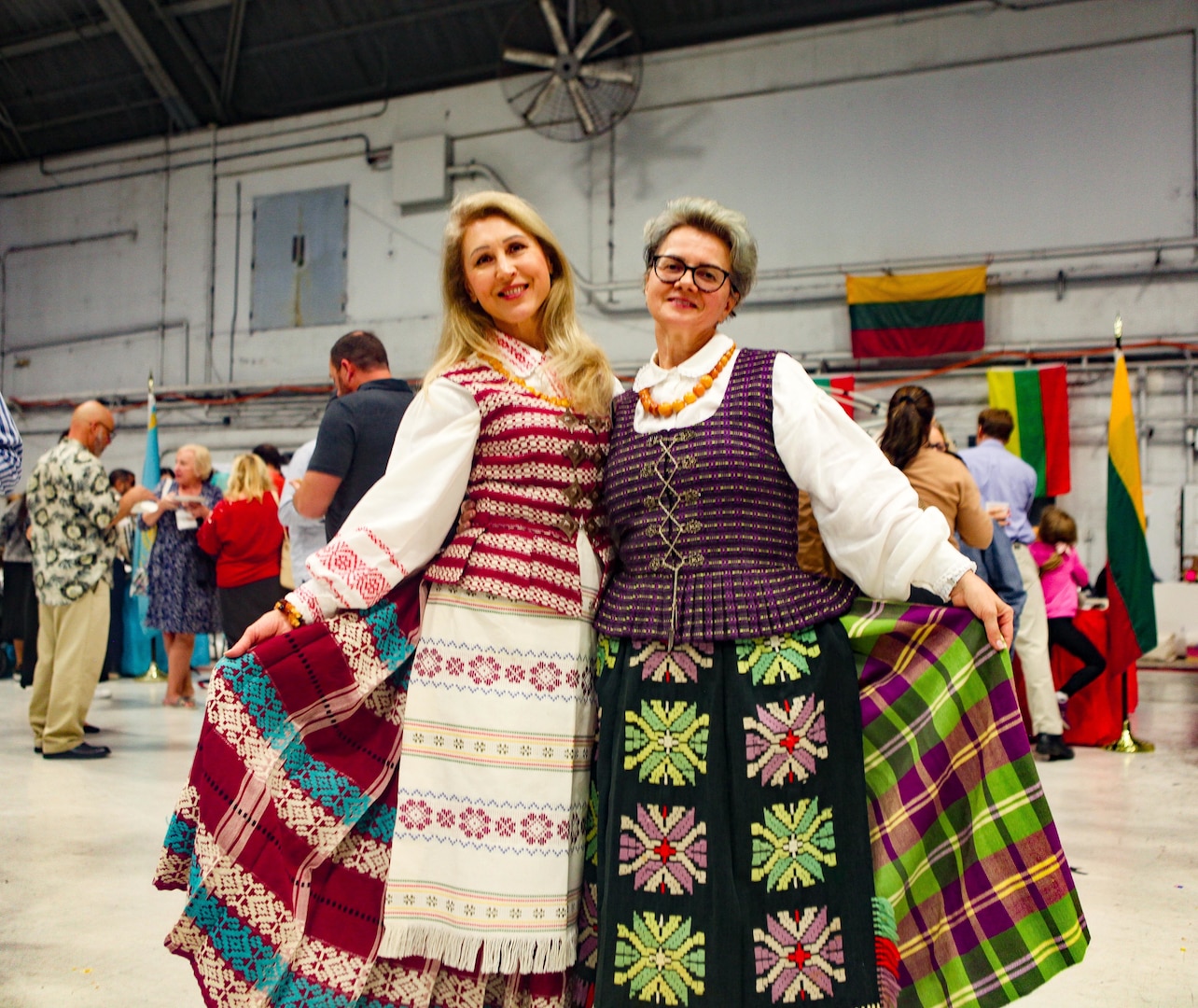 TAMPA, Fla. - Two ladies pose for a photo during U.S. Central Command’s (CENTCOM) International Night, Dec. 07, 2023. International Night started in December 2004 as a winter holiday party for the Coalition members and families. This year, members of CENTCOM’s coalition countries displayed native customs and offered a taste of their traditional cuisines to guests. (U.S. Central Command Public Affairs photo by Maged Benjamin-Elias)