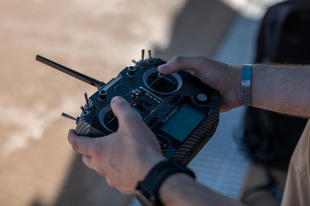 A U.S. Marine with III Marine Expeditionary Force remotely controls an unmanned service vessel during Innovation Boot Camp on Camp Hansen, Okinawa, Japan, Dec. 8, 2023. IBC was designed to teach Marines skills such as welding, 3D printing, coding, and programming to create innovative products for the Marine Corps and to test Marines’ critical thinking skills. (U.S. Marine Corps photo by Lance Cpl. Manuel Alvarado)