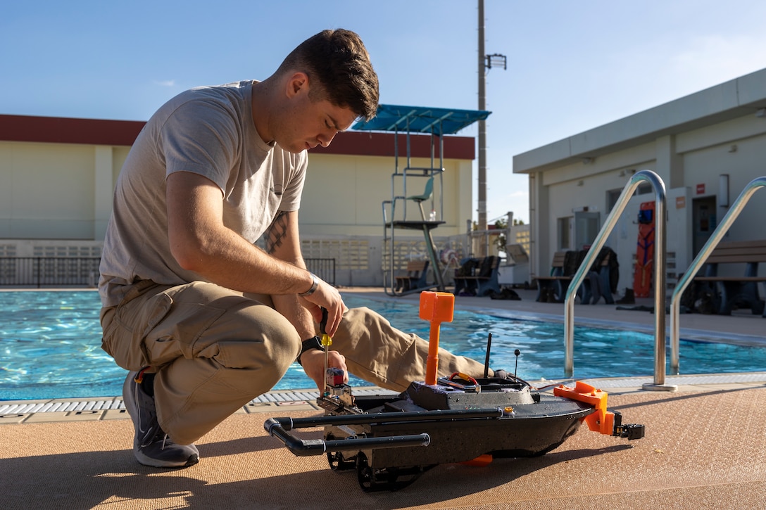 U.S. Marine Corps Cpl. Andrew Jeter, an aviation meteorological equipment maintenance technician with III Marine Expeditionary Force Information Group, adjusts an unmanned service vessel during Innovation Boot Camp on Camp Hansen, Okinawa, Japan, Dec. 8, 2023. IBC was designed to teach Marines skills such as welding, 3D printing, coding, and programming to create innovative products for the Marine Corps and to test Marines’ critical thinking skills. Jeter is a native of Chocowinity, North Carolina. (U.S. Marine Corps photo by Lance Cpl. Manuel Alvarado)