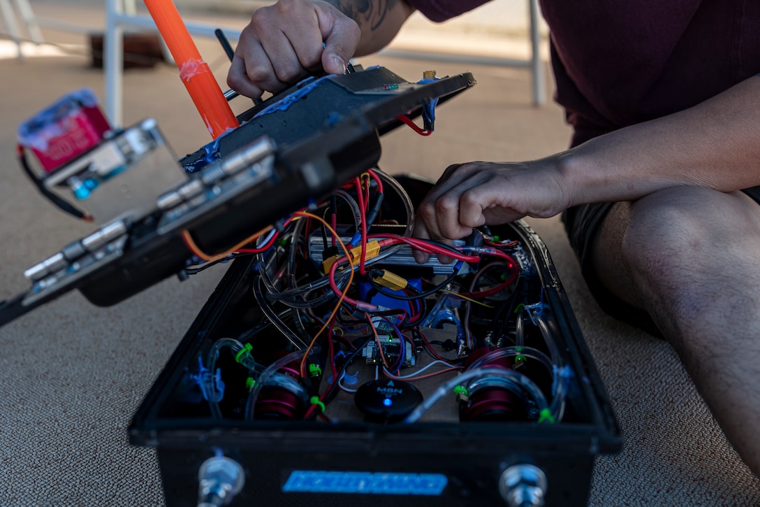 U.S. Marine Corps Lance Cpl. Angel Villanueva, a digital wideband maintainer with 3rd Intelligence Battalion, III Marine Expeditionary Force Information Group, adjusts an unmanned service vessel during Innovation Boot Camp on Camp Hansen, Okinawa, Japan, Dec. 8, 2023. IBC was designed to teach Marines skills such as welding, 3D printing, coding, and programming to create innovative products for the Marine Corps and to test Marines’ critical thinking skills. Villanueva is a native of Houston, Texas. (U.S. Marine Corps photo by Lance Cpl. Manuel Alvarado)