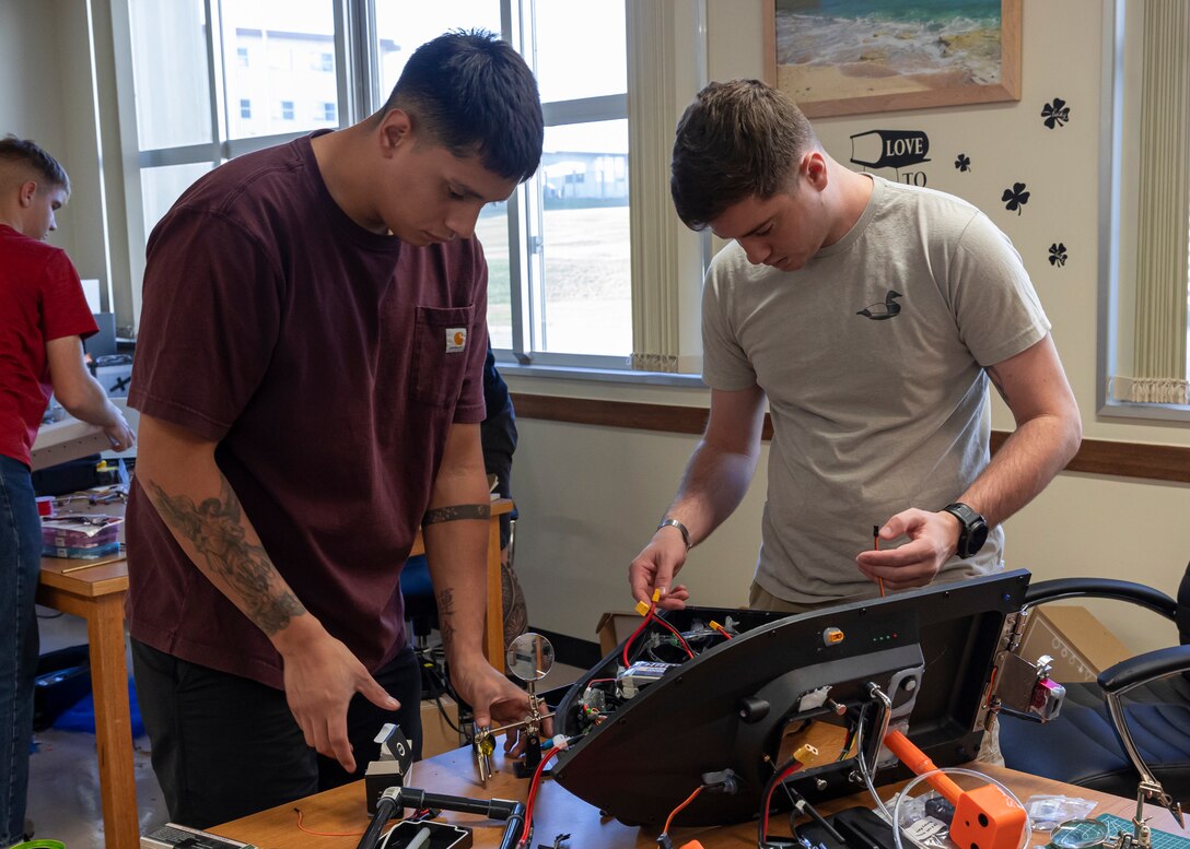 U.S. Marine Corps Lance Cpl. Angel Villanueva, left, a digital wideband maintainer, and Cpl. Andrew Jeter, an aviation meteorological equipment maintenance technician, both with 3rd Intelligence Battalion, III Marine Expeditionary Force Information Group, build an unmanned service vessel during Innovation Boot Camp on Camp Hansen, Okinawa, Japan, Dec. 8, 2023. IBC was designed to teach Marines skills such as welding, 3D printing, coding, and programming to create innovative products for the Marine Corps and to test Marines’ critical thinking skills. Villanueva is a native of Houston, Texas, and Jeter is a native of Chocowinity, North Carolina. (U.S. Marine Corps photo by Lance Cpl. Manuel Alvarado)