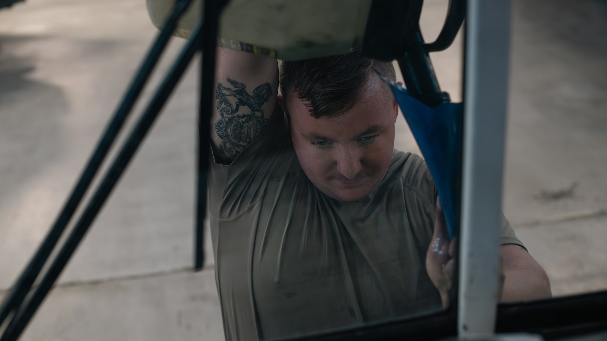 Airman refills coolant on a bus.