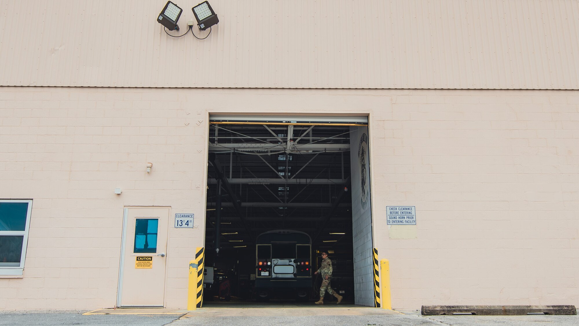 Airman walks around a vehicle.