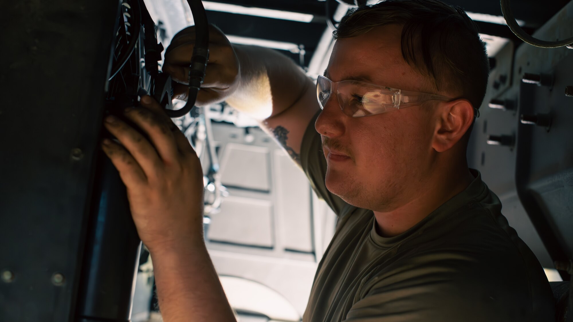 Airman repairs bus.