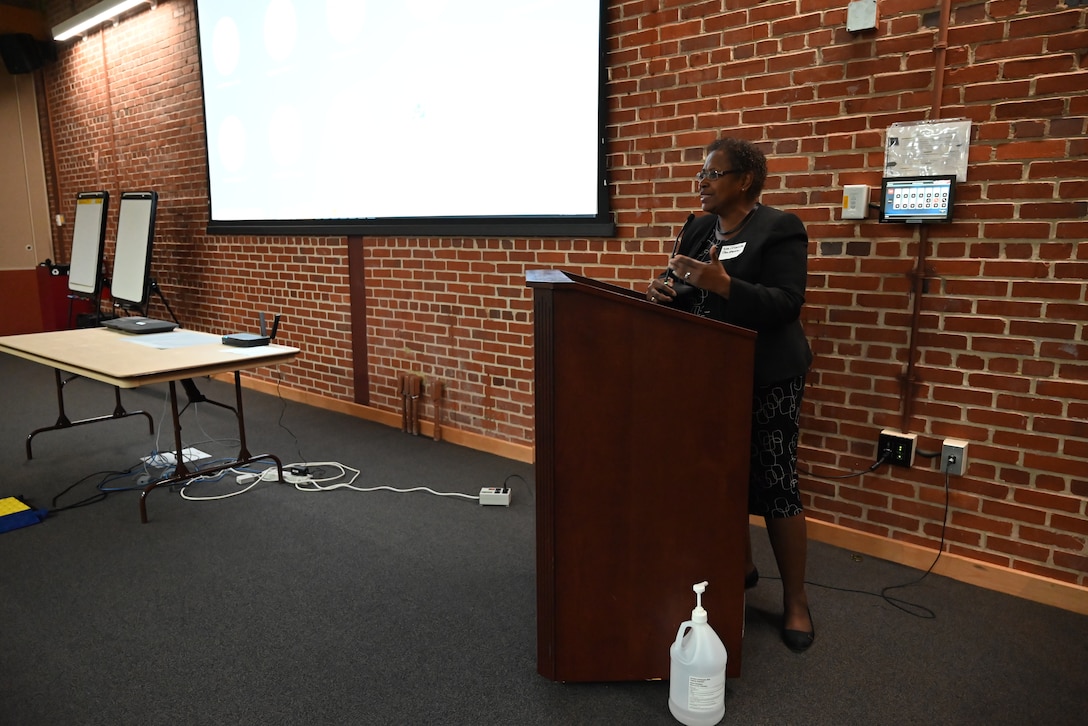 Woman stands at podium