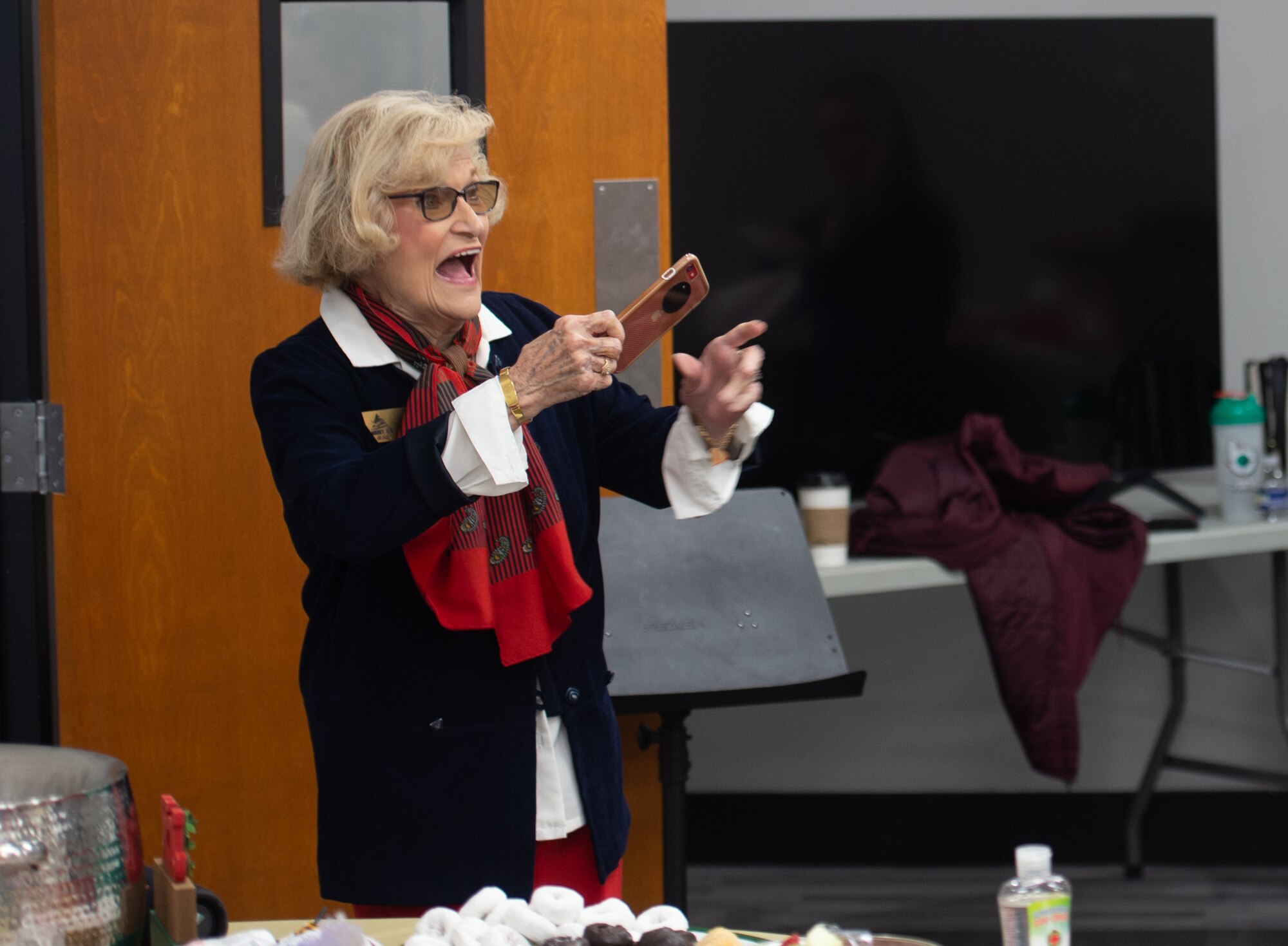 Dr. Lucy Greene, Moody Support Committee, takes a photo during the annual cookie drive at Moody Air Force Base, Georgia, Dec.11, 2023. Spouses and community members made and donated more than 13,000 cookies. (U.S. Air Force photo by Airman Cade Ellis)