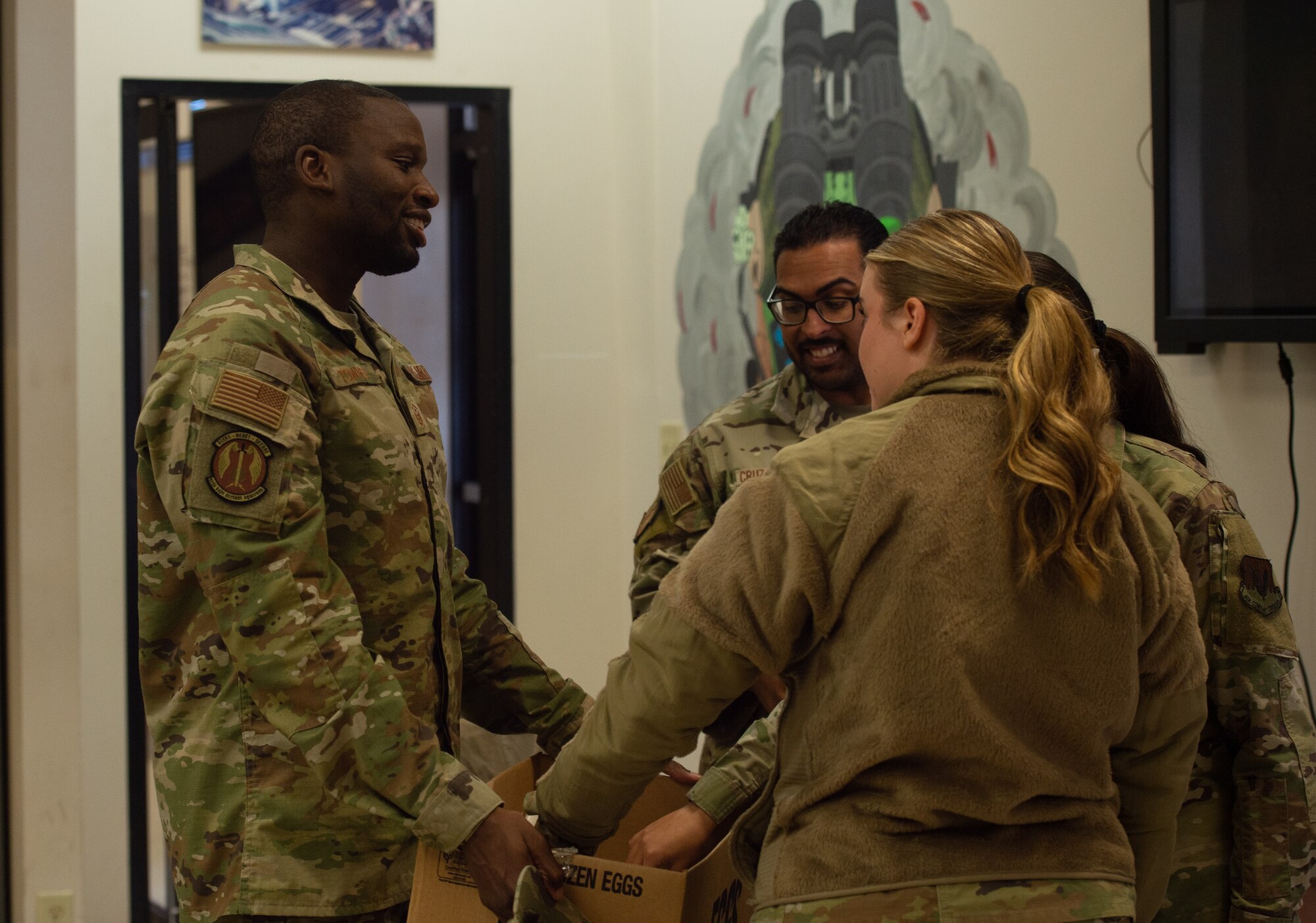 Airmen from the 823rd Base Defense Squadron receive holiday cookies at Moody Air Force Base, Georgia, Dec. 11, 2023.With the help of volunteers, over 650 packages of cookies were created, ensuring unaccompanied Airmen received cookies to help them welcome the holiday season with a feeling of support. (U.S. Air Force photo by Airman Cade Ellis)