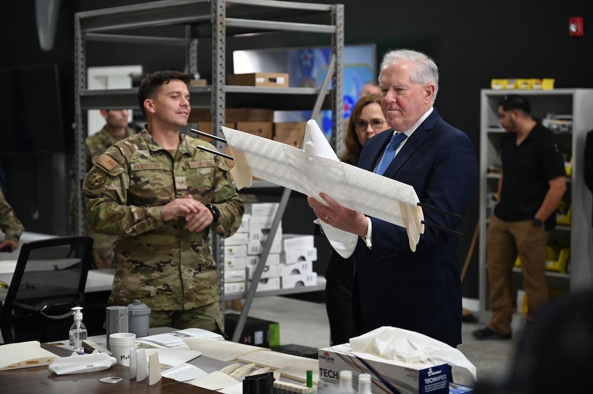 A Task Force-99 Airman explains to Secretary of the Air Force Frank Kendall how unmanned aircraft can tactically deploy at an undisclosed location in the U.S. Central Command area of responsibility