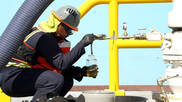 A member in support of Joint Task Force-Red Hill (JTF-RH) inspects the quality of fuel from the Red Hill Bulk Fuel Storage Facility (RHBFSF) at Joint Base Pearl Harbor-Hickam, Hawaii Dec. 7, 2023.