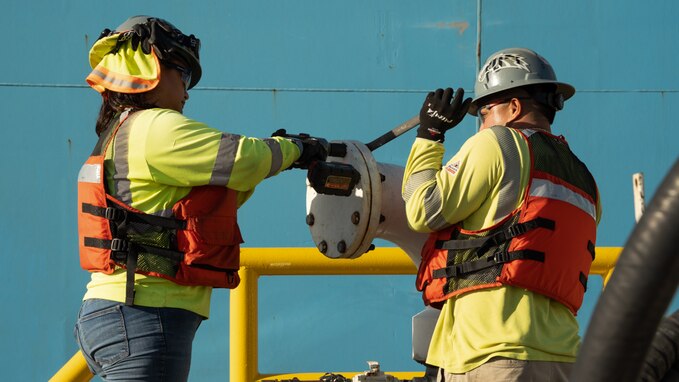 Personnel in support of Joint Task Force-Red Hill (JTF-RH) disconnect fuel lines from merchant tanker Yosemite Trader, completing the process of gravity draining the Red Hill Bulk Fuel Storage Facility (RHBFSF) flowable tank bottoms, at Joint Base Pearl Harbor-Hickam, Hawaii Dec. 7, 2023.