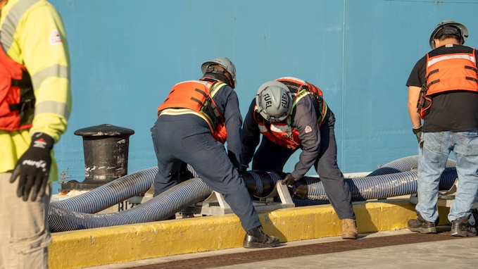 Personnel in support of Joint Task Force-Red Hill (JTF-RH) disconnect fuel lines from merchant tanker Yosemite Trader, completing the process of gravity draining the Red Hill Bulk Fuel Storage Facility (RHBFSF) flowable tank bottoms, at Joint Base Pearl Harbor-Hickam, Hawaii Dec. 7, 2023.