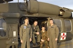 Members of the Oregon Army National Guard’s 1042nd Medical Company, Lt. Col Dan Hokanson, pilot in charge, crew chiefs Staff Sgt. Mark Braeme and Sgt. Rob Armstrong, and Capt. Bryan Houston, pilot, pose in front of a Black Hawk helicopter Dec. 15, 2003. The crew, including Staff Sgt. Travis Powell, flight medic, were credited with saving the lives of two kayakers on Oregon’s Sandy River following an over-water air rescue during a winter storm and rising flood waters.