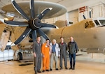 John Engelbrecht stands in front of an E-2D Hawkeye, flanked on the left by Lt. Cmdr. Bradley Roby and Ben Hashi, flight test engineer. To his right are Lt. Cmdr. David Chapelle and Engelbrecht’s son, Scott Engelbrecht. Scott Engelbrecht contacted Naval Air Systems Command and Naval Air Warfare Center Aircraft Division, who helped arrange a tour of Naval Air Station Patuxent River, Maryland.