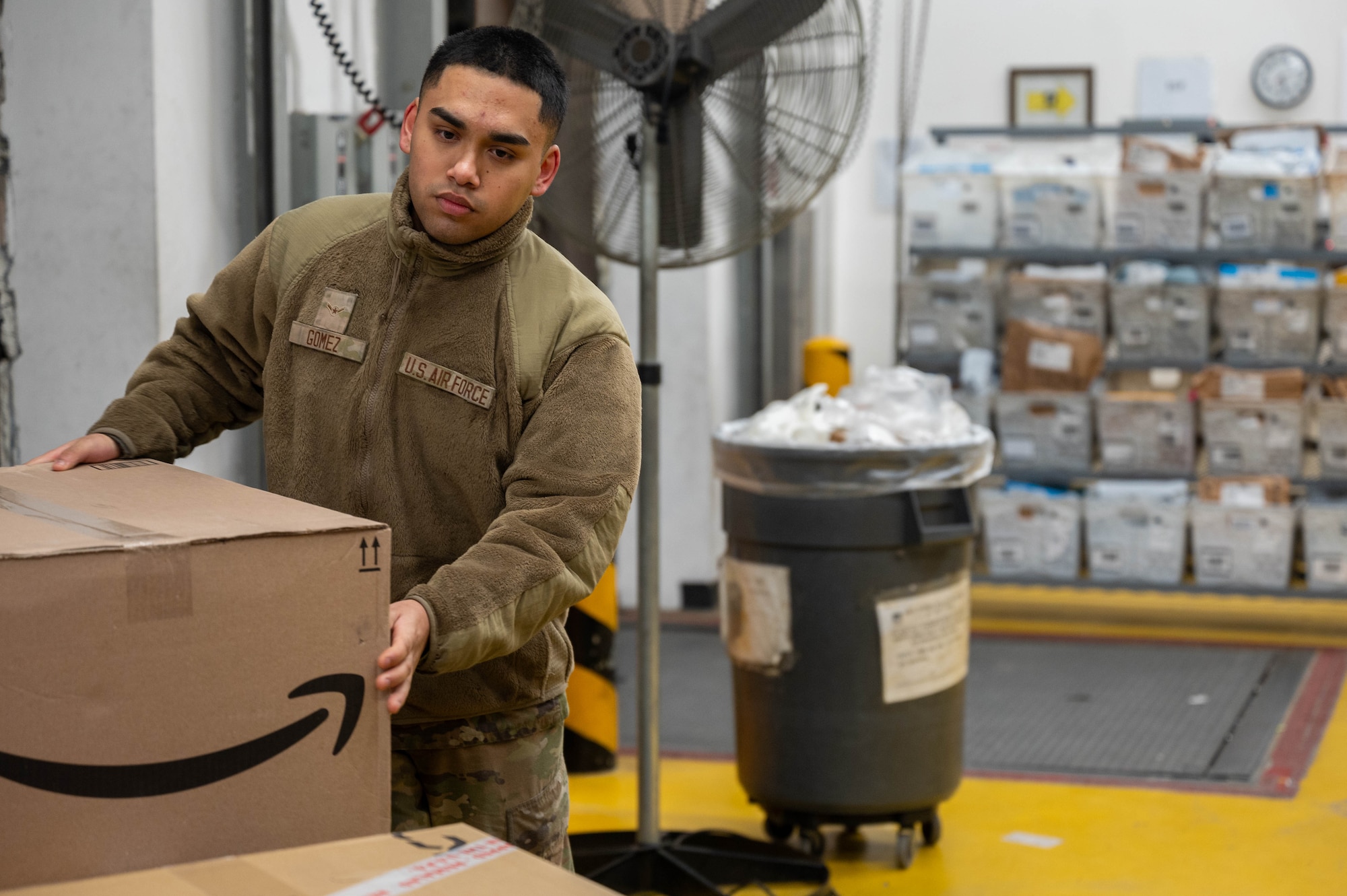 U.S. Air Force Airman Damian Gomez, 51st Force Support Squadron military postal clerk, unloads boxes from a mail truck at Osan Air Base, Republic of Korea, Dec. 12, 2023. The post office unloads, organizes, and distributes between hundreds and thousands of parcels daily, allowing Airmen and their families to send items to each other freely. (U.S. Air Force photo by Airman 1st Class Chase Verzaal)