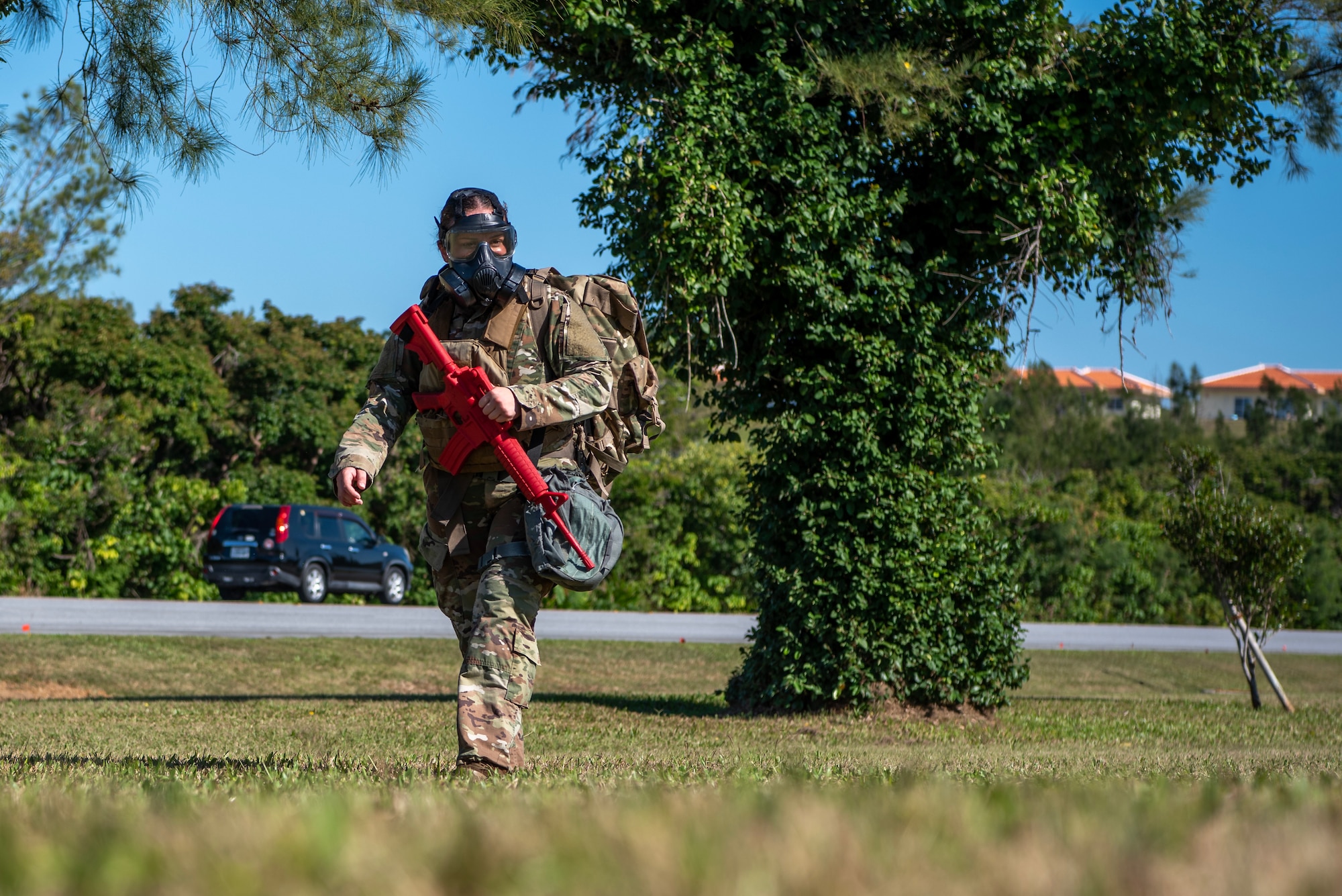 military member walking with a gas mask