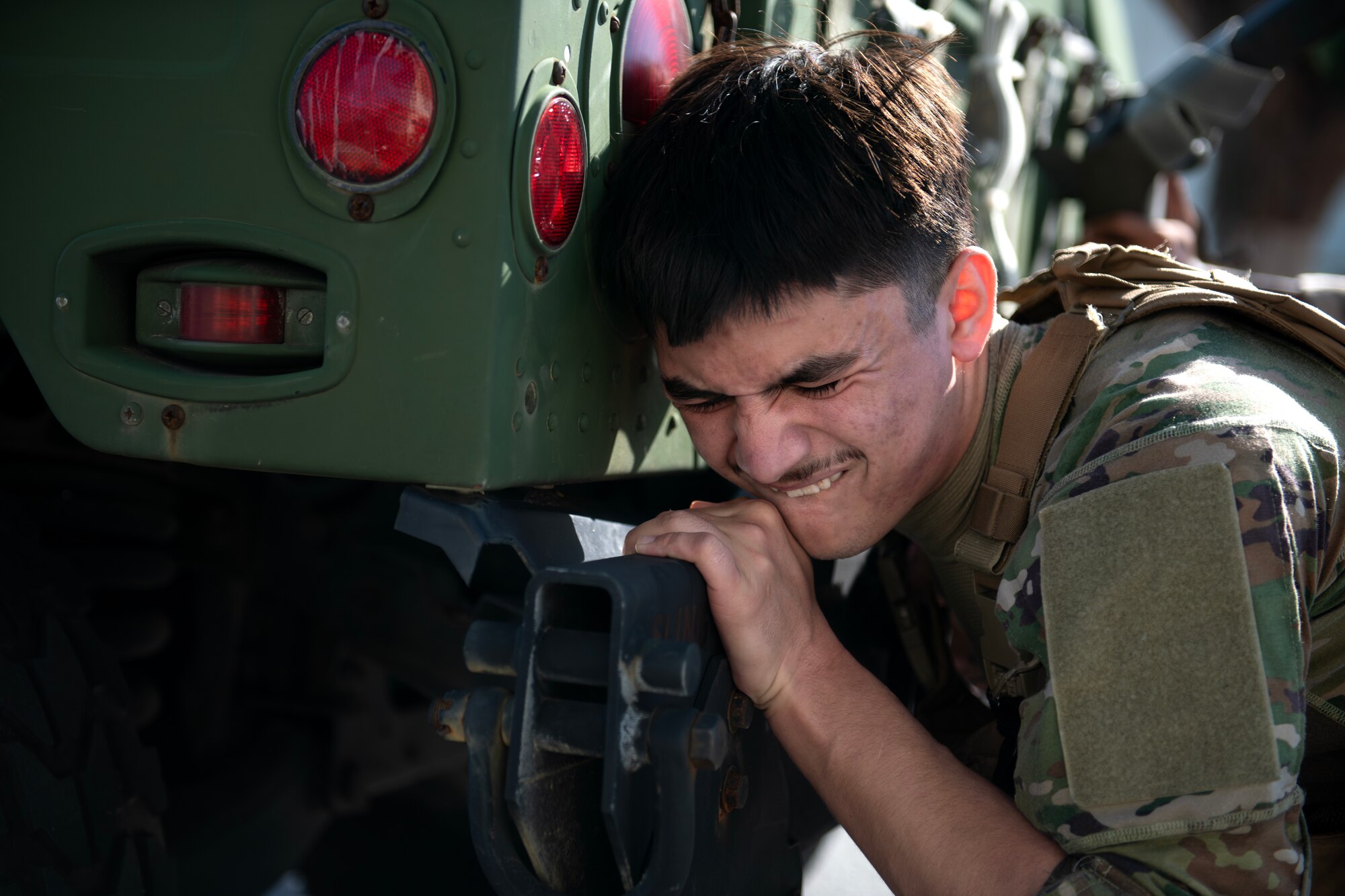 military member pushes humvee upclose