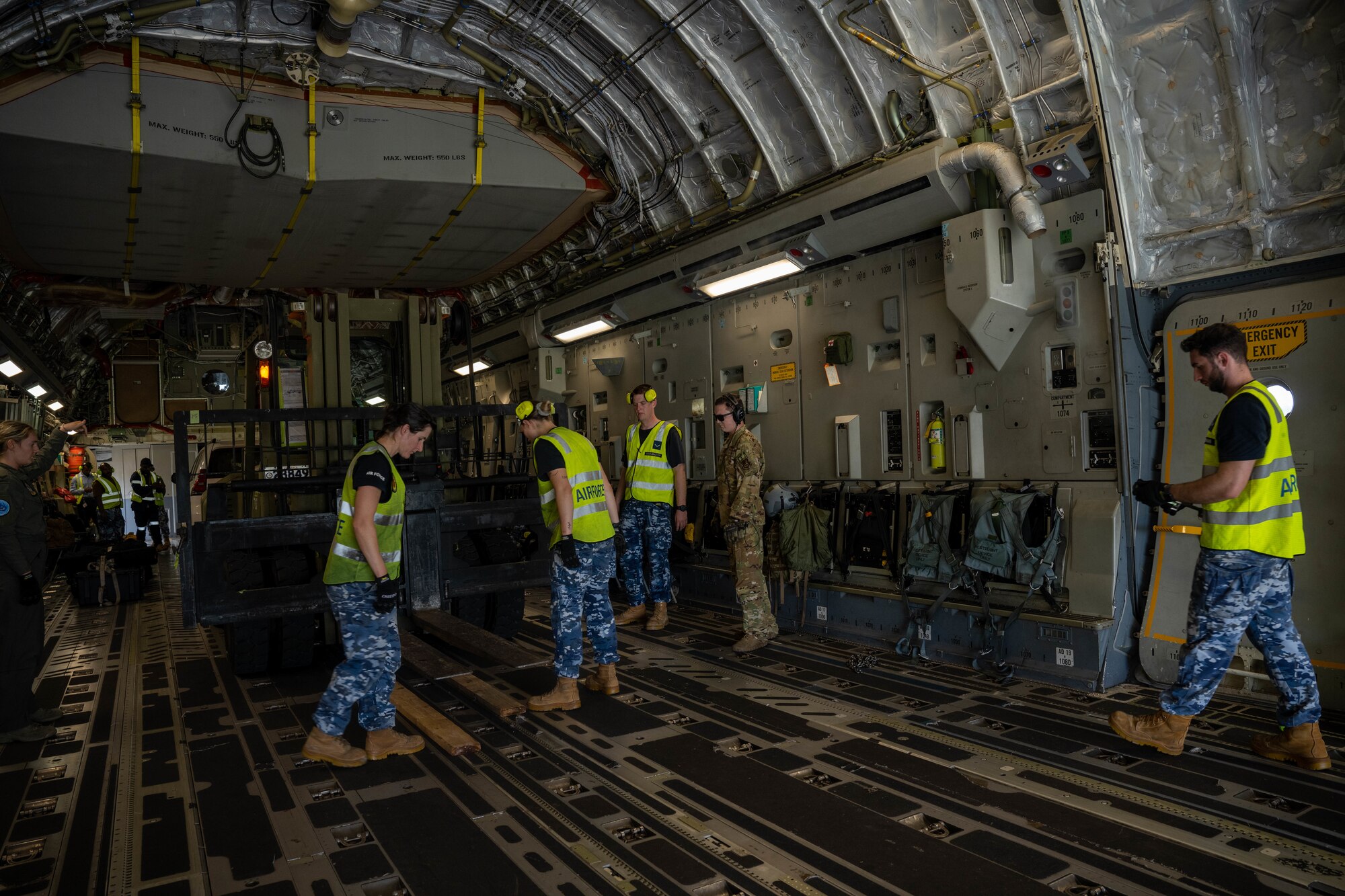 U.S. Air Force Airmen assigned to the 535th Airlift Squadron work alongside Royal Australian Air Force Airmen assigned to the No. 36 Squadron to secure cargo at Momote Airport, Papua New Guinea, Dec. 5, 2023. The exercise demonstrates the key partnership and interoperability between the U.S. and Australia that allows continued security and stability in the Indo-Pacific region. (U.S. Air Force photo by Senior Airman Makensie Cooper)