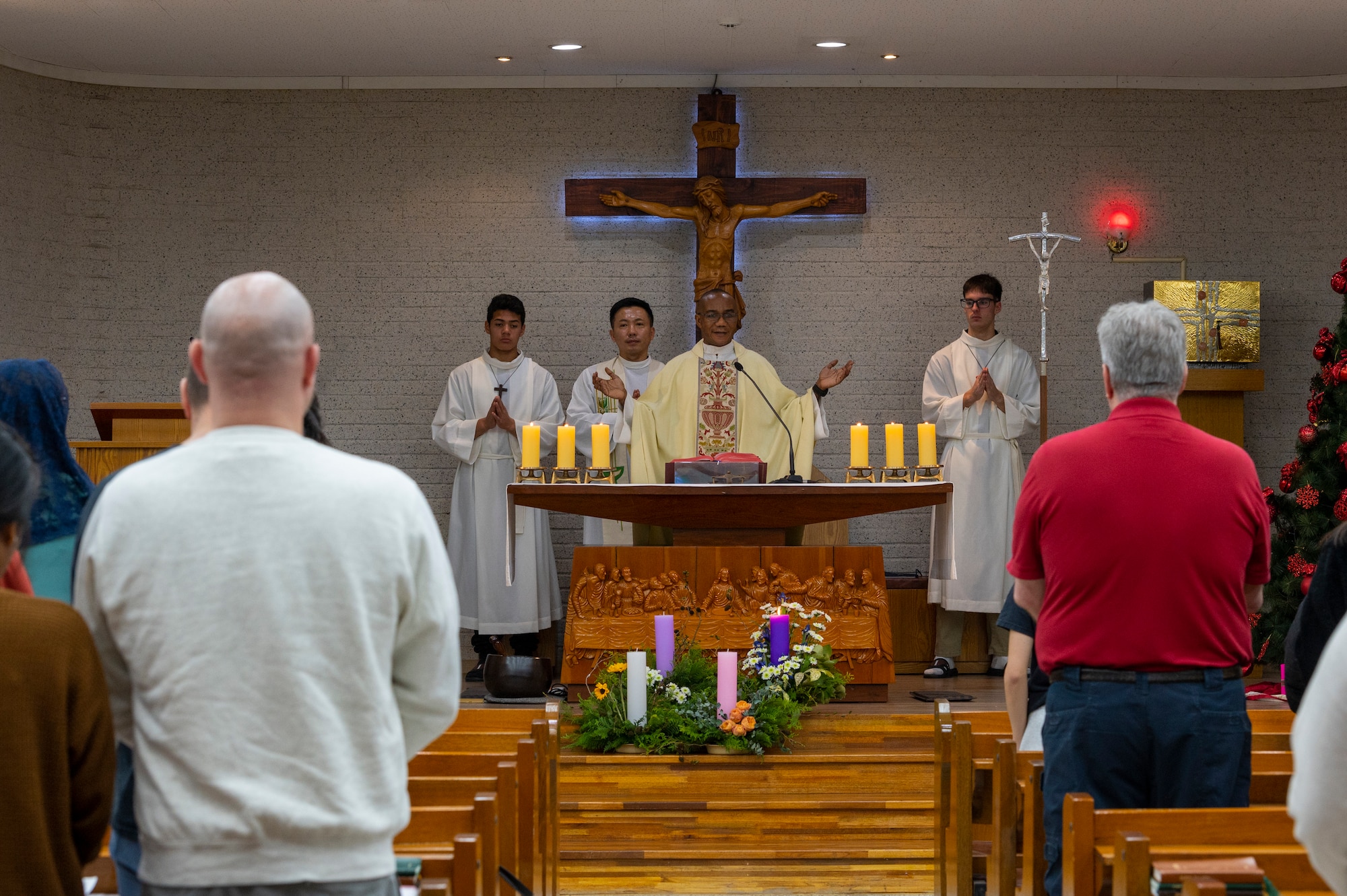 U.S. Air Force Capt. Nelson Ogwuegbu, 51st Fighter Wing chaplain, leads prayer during a joint Catholic mass at Osan Air Base, Republic of Korea, Dec. 8, 2023. The USAF chaplain corps supports the Constitutional right to freely exercise religion for all Airmen and their families. (U.S. Air Force photo by Senior Airman Kaitlin Castillo)