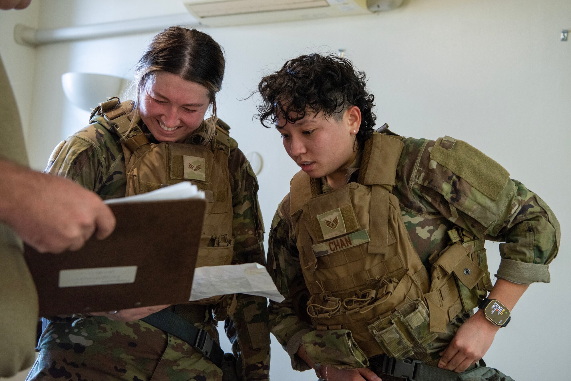 military members look at coordinates page