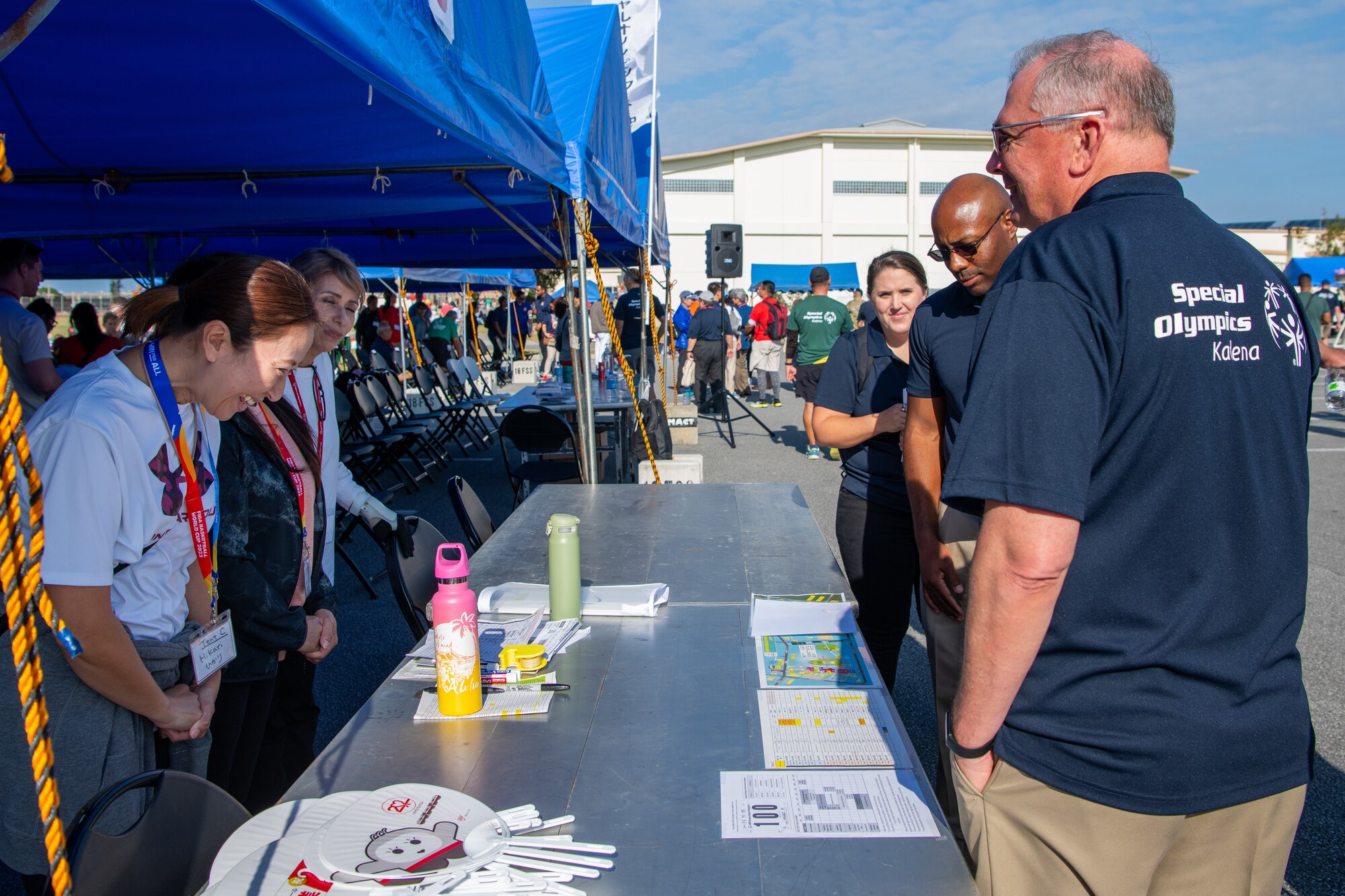 Volunteers greet U.S. Air Force Lt. Gen. Ricky Rupp.