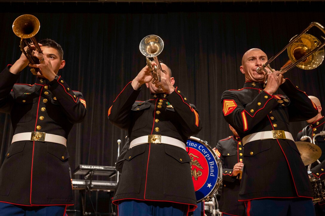 Marine Corps Cpl. Dominic Muller, left, Sgt. James Dawson, center, and Sgt. Seth Parrish perform during a holiday concert at Marine Corps Base Quantico, Va., Dec. 10, 2023.
