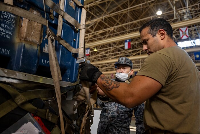 A 35th Logistics Readiness Squadron member secures cargo on a pallet during a Port Dawg Challenge at Misawa Air Base, Japan, Dec. 8, 2023.