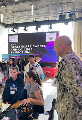 SAN DIEGO (Dec. 7, 2023) Looking on, Capt. Eric R.  Welsh, commanding officer, Naval Health Research Center and research scientist Hedaya Rizeq explain to students how “mind reading” worked by displaying brain-computer interface capabilities. Supporting STEM programs is a fundamental part of NHRC’s community outreach effort. 

(U.S. Navy photo by John Marciano/released)