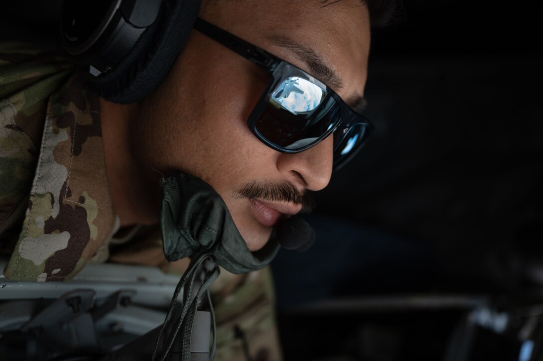 An airman wearing dark glasses looks down.